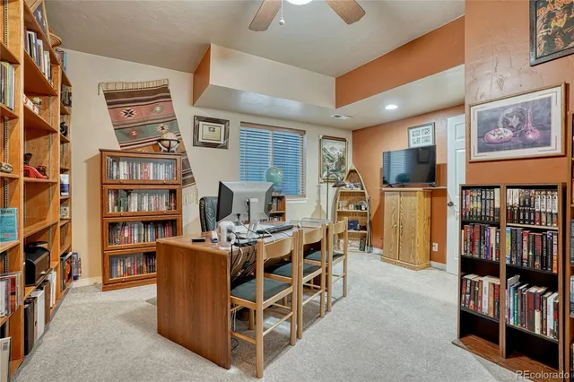 a living room with furniture a flat screen tv and kitchen view
