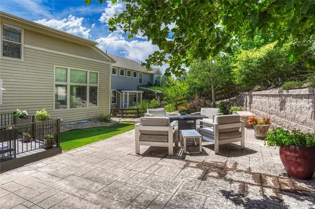 a view of a patio with table and chairs and potted plants
