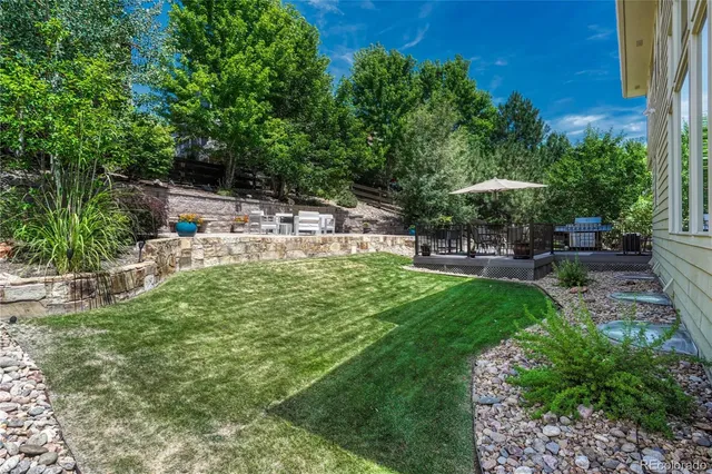 a view of a house with backyard and sitting area