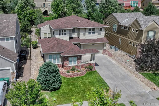 an aerial view of multiple houses with yard
