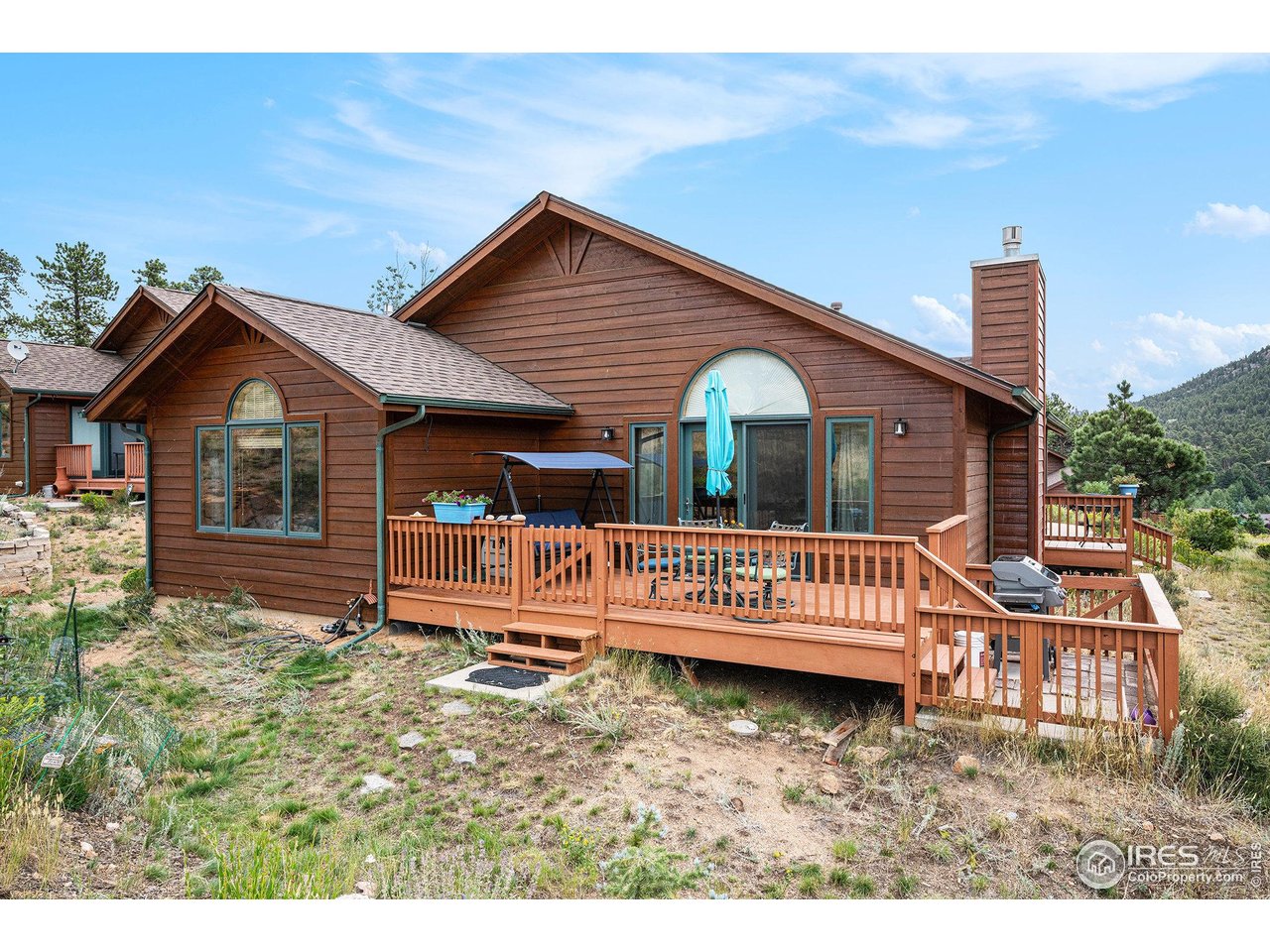 677 Cedar Ridge Circle, Unit 5 Estes Park, CO 80517 - Photo 10 of 20 Back deck with furniture & BBQ