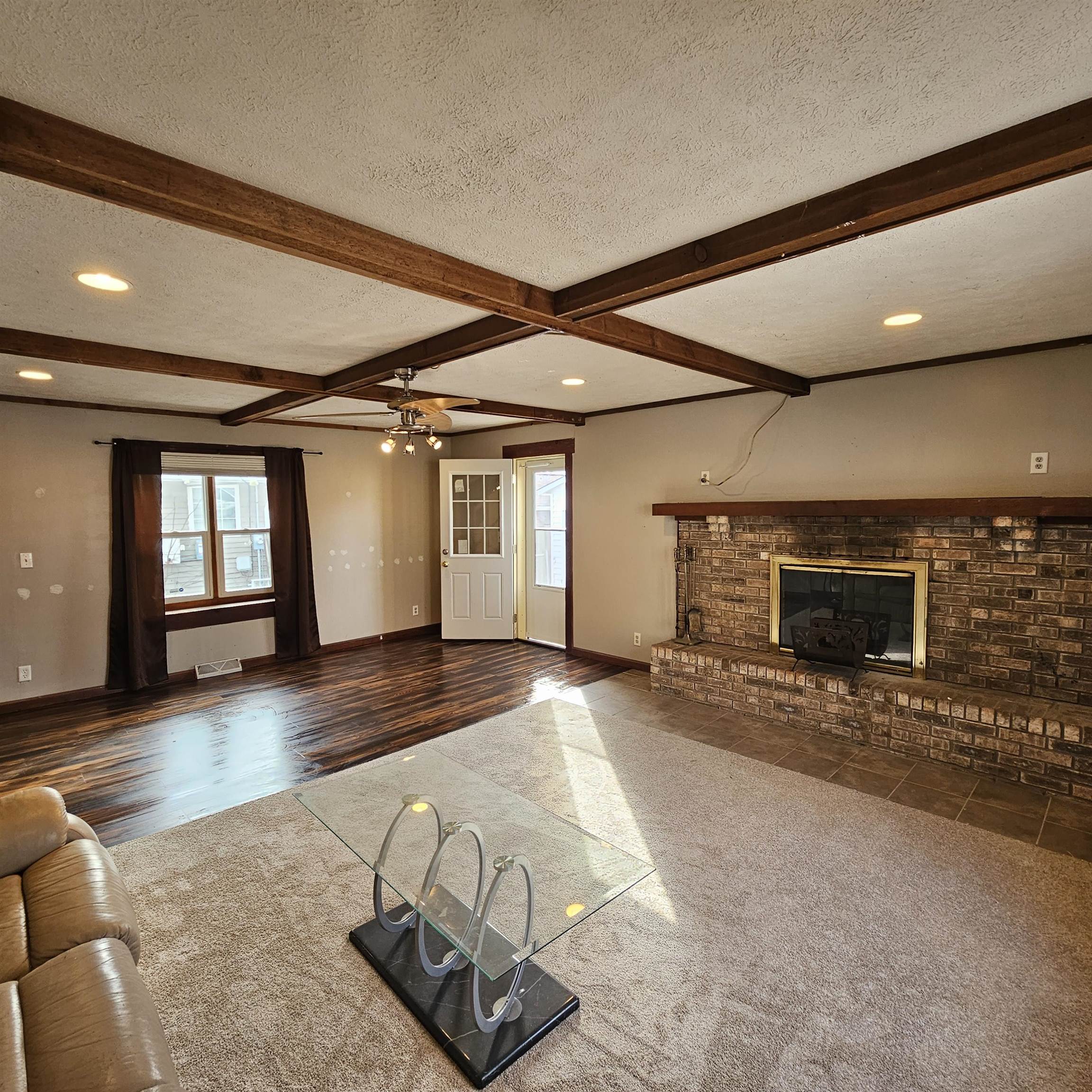 1925 Remington Road Rockford, IL 61108 - Photo 3 of 14 a view of a hall with wooden floor and a fireplace