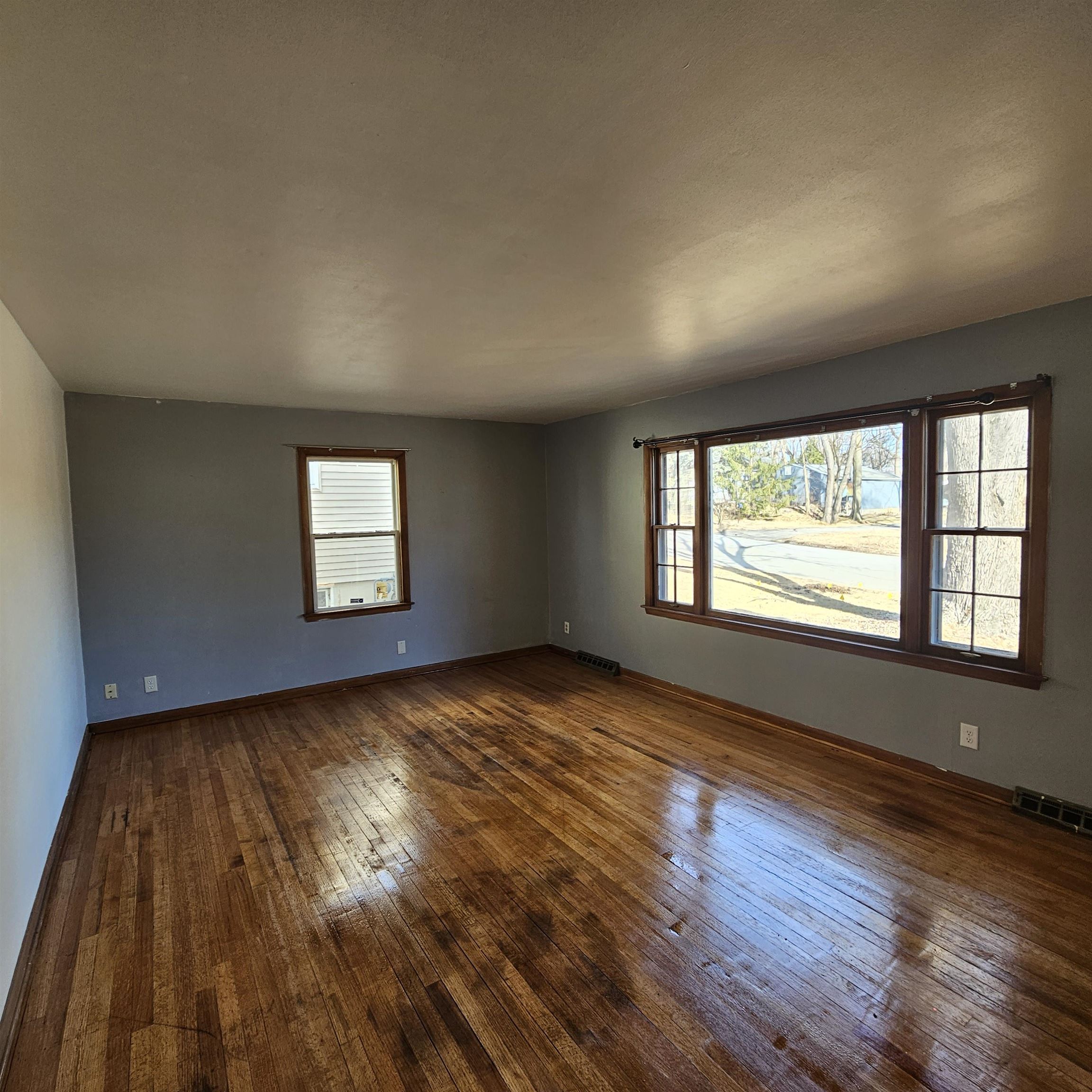 1925 Remington Road Rockford, IL 61108 - Photo 7 of 14 an empty room with wooden floor and windows