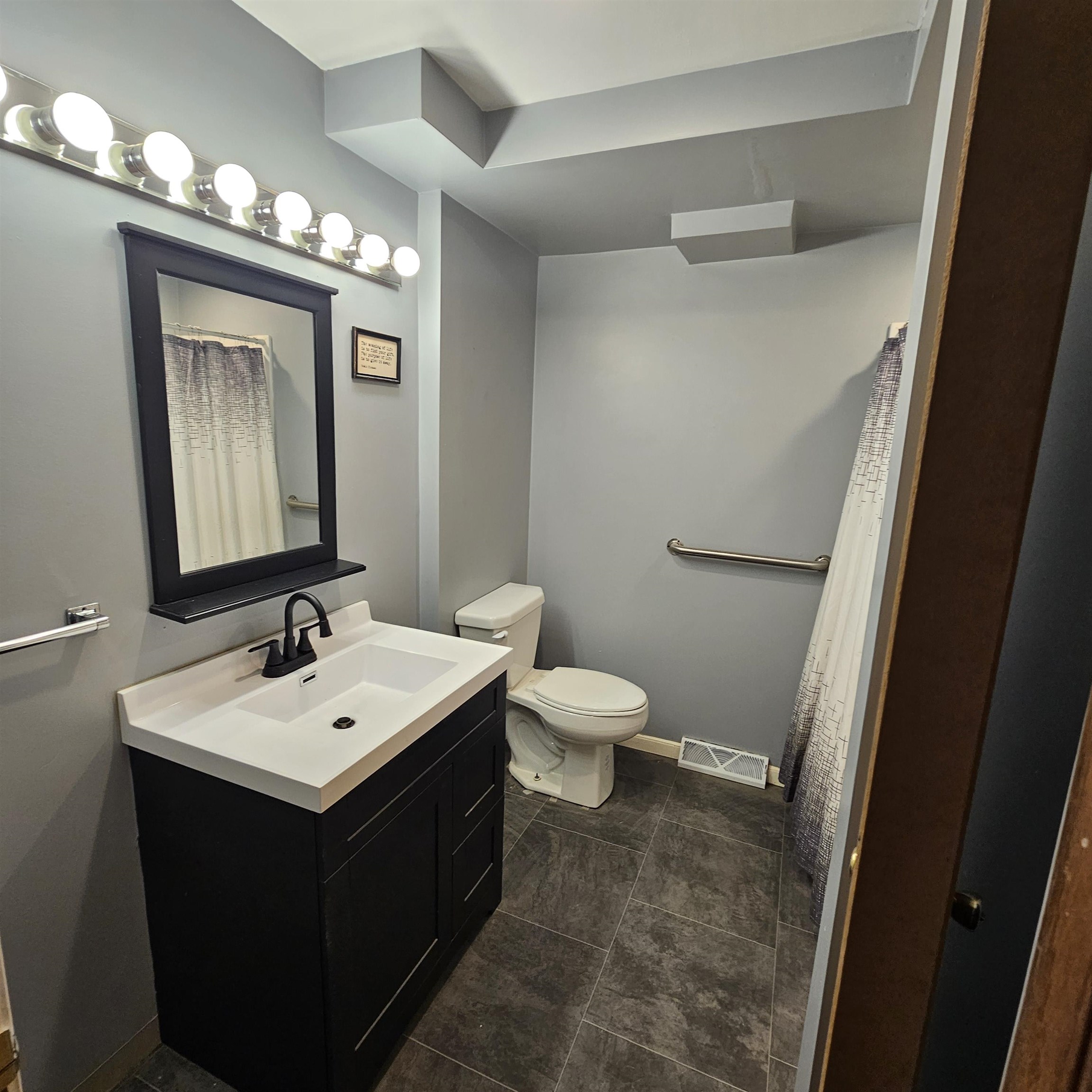 1925 Remington Road Rockford, IL 61108 - Photo 8 of 14 a bathroom with a toilet sink and mirror