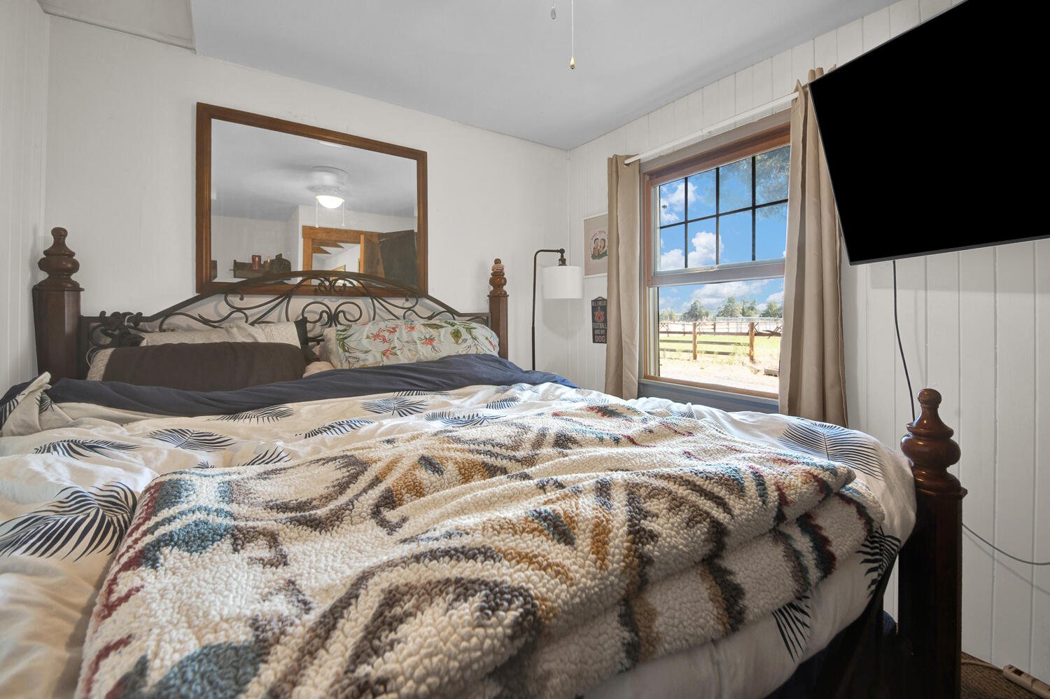 67100 Fryrear Road Bend, OR 97703 - Photo 16 of 38 a bedroom with a bed and flat screen tv