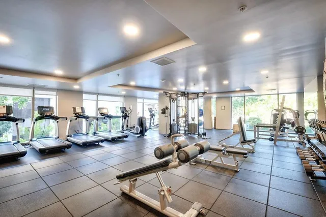 a view of a patio with couches and a table and chairs with wooden floor