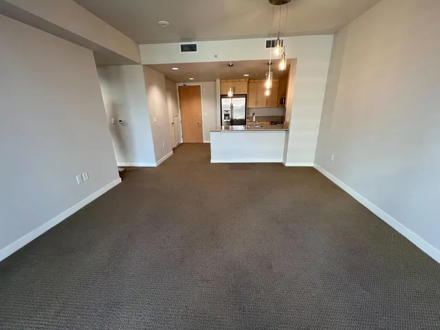 a view of a hallway with a kitchen