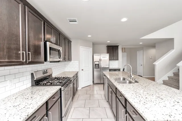 a kitchen with a stove and a sink