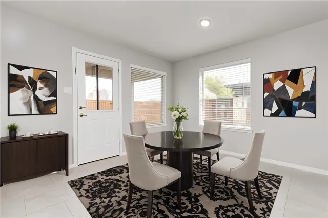 a dining room with furniture and window