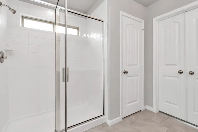 a bathroom with a glass shower door