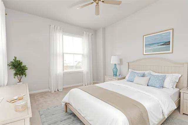 a bedroom with a large bed and a potted plant