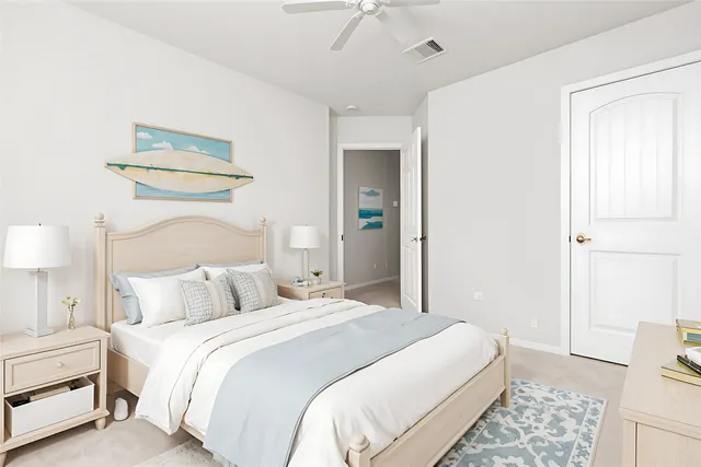 a bedroom with a bed and a lamp