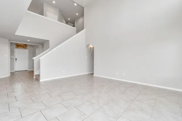 a view of an empty room with stairs