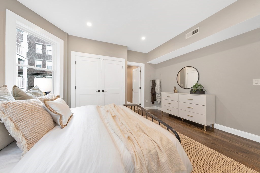 87 Parkton Road, Unit 3 Boston, MA 02130 - Photo 13 of 38 a bedroom with a bed mirror and window