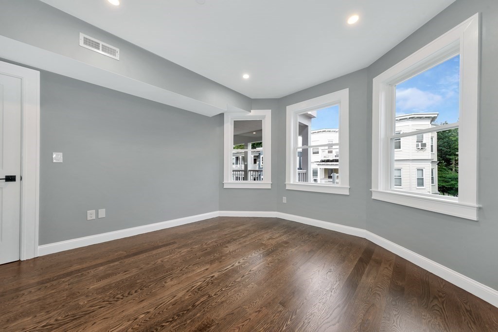87 Parkton Road, Unit 3 Boston, MA 02130 - Photo 27 of 38 a view of an empty room with wooden floor and a window