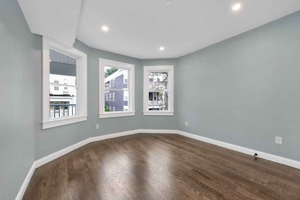 87 Parkton Road, Unit 3 Boston, MA 02130 - Photo 28 of 38 a view of an empty room with wooden floor and a window