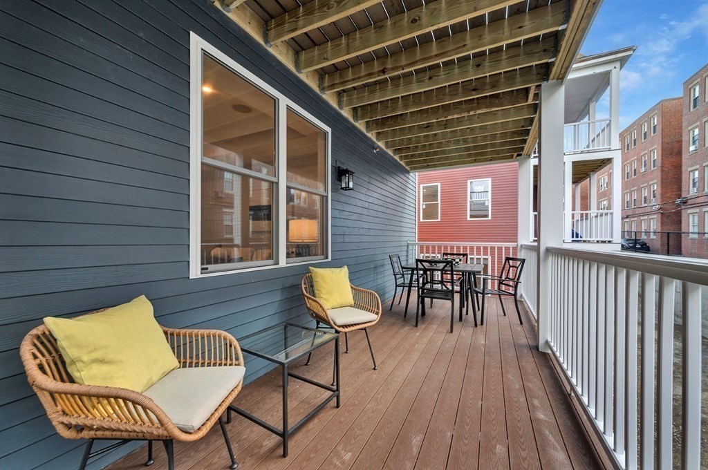87 Parkton Road, Unit 3 Boston, MA 02130 - Photo 32 of 38 a balcony with chairs and wooden floor
