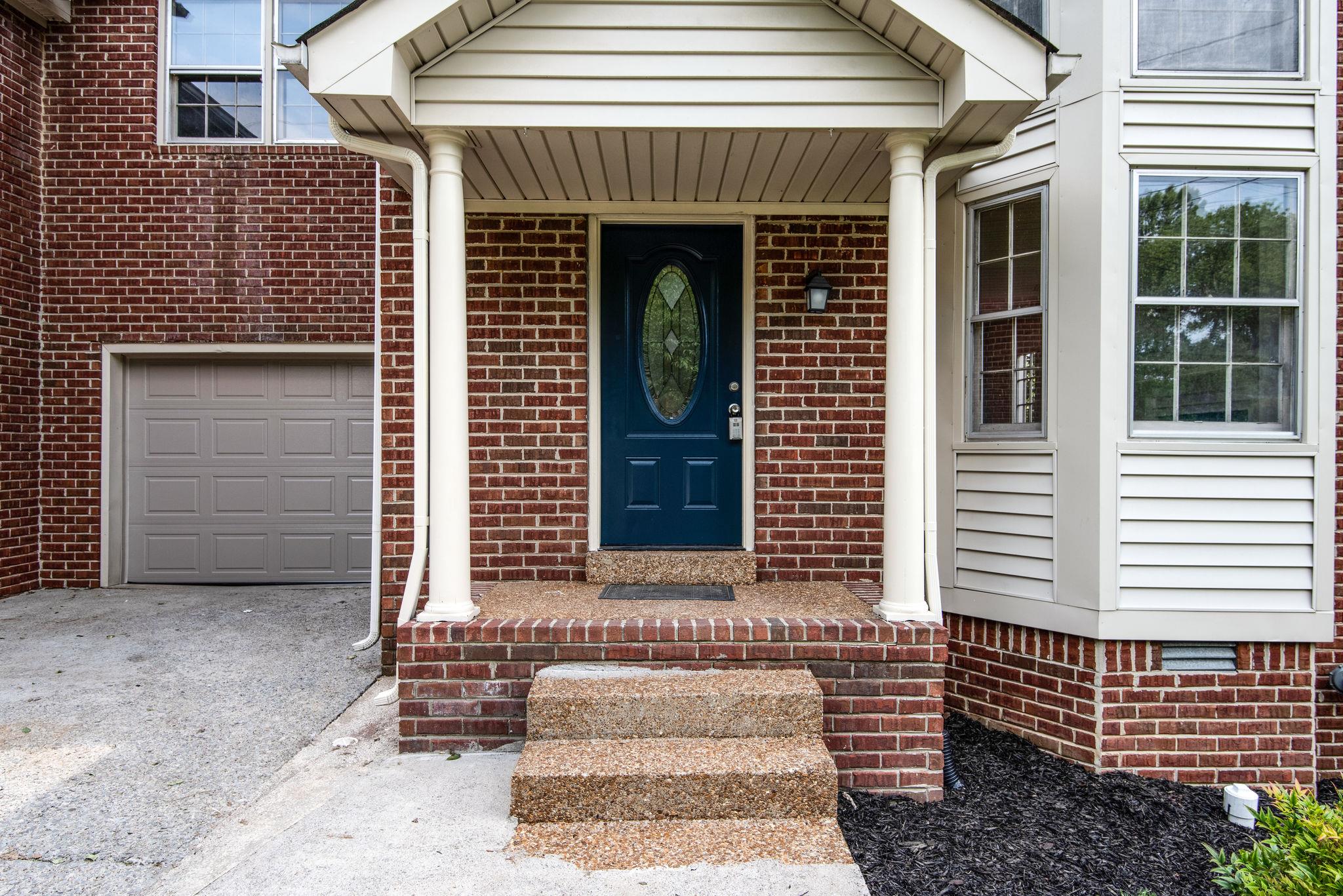 2327 Rader Ridge Road Antioch, TN 37013 - Photo 3 of 27 a front view of a house with a garden