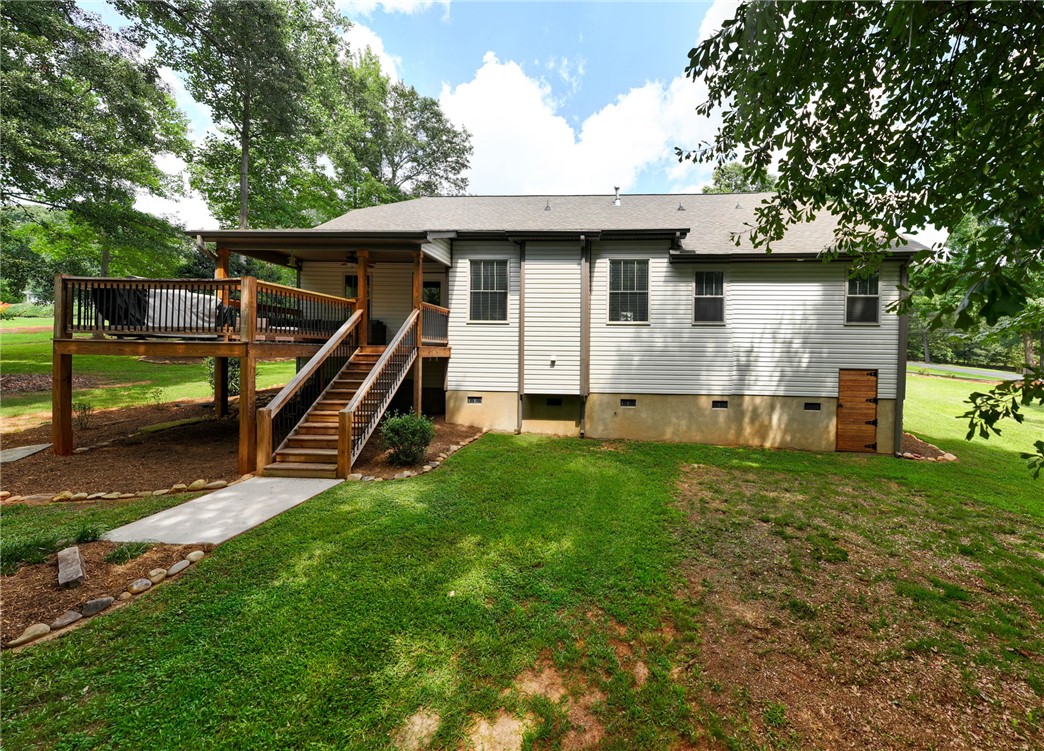 201 Hearthstone Drive Anderson, SC 29621 - Photo 45 of 49 A spacious wooden deck with a covered area extends from the home's rear, offering elevated outdoor living.