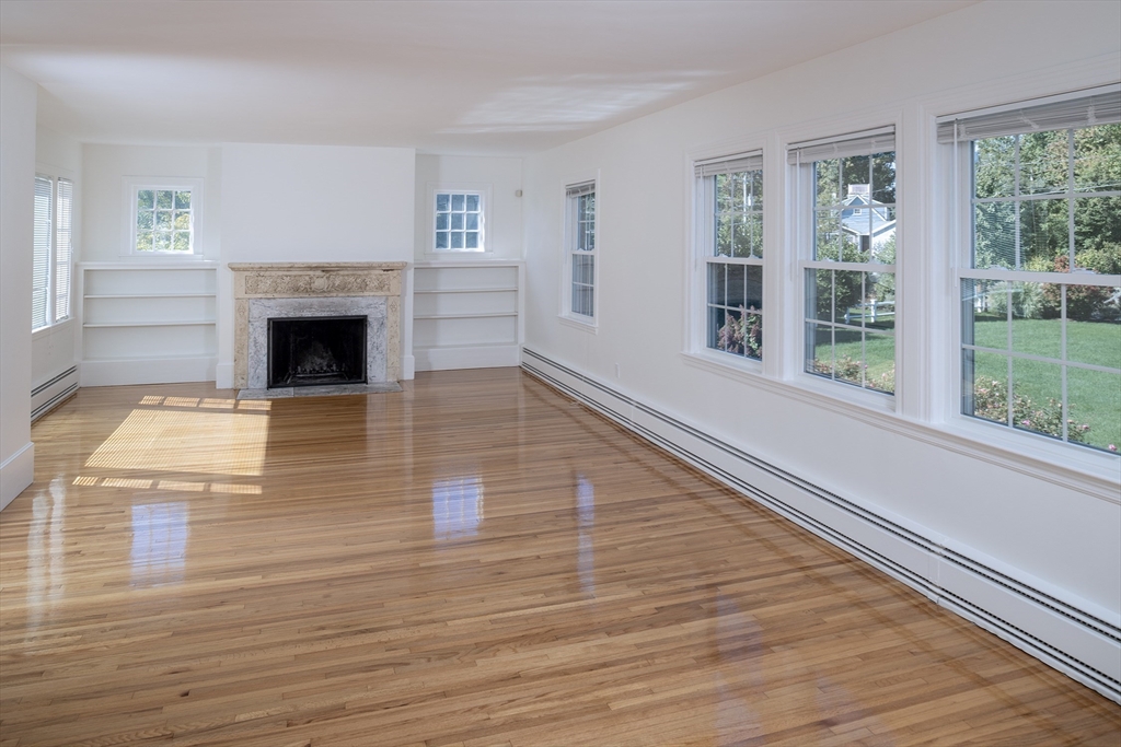 75 Nichols Road Cohasset, MA 02025 - Photo 5 of 15 a view of a livingroom with wooden floor a fireplace and windows