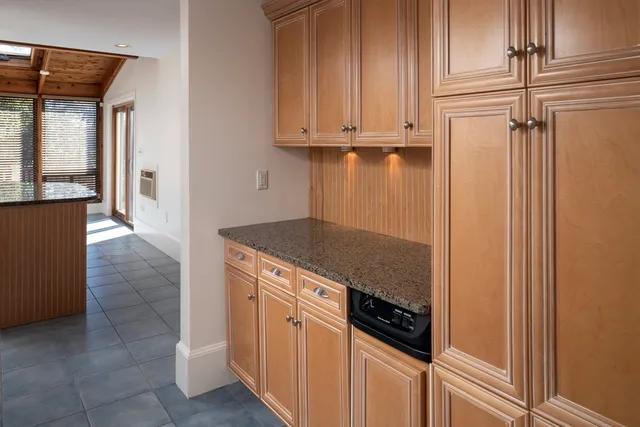 a kitchen with stainless steel appliances granite countertop a refrigerator and a stove
