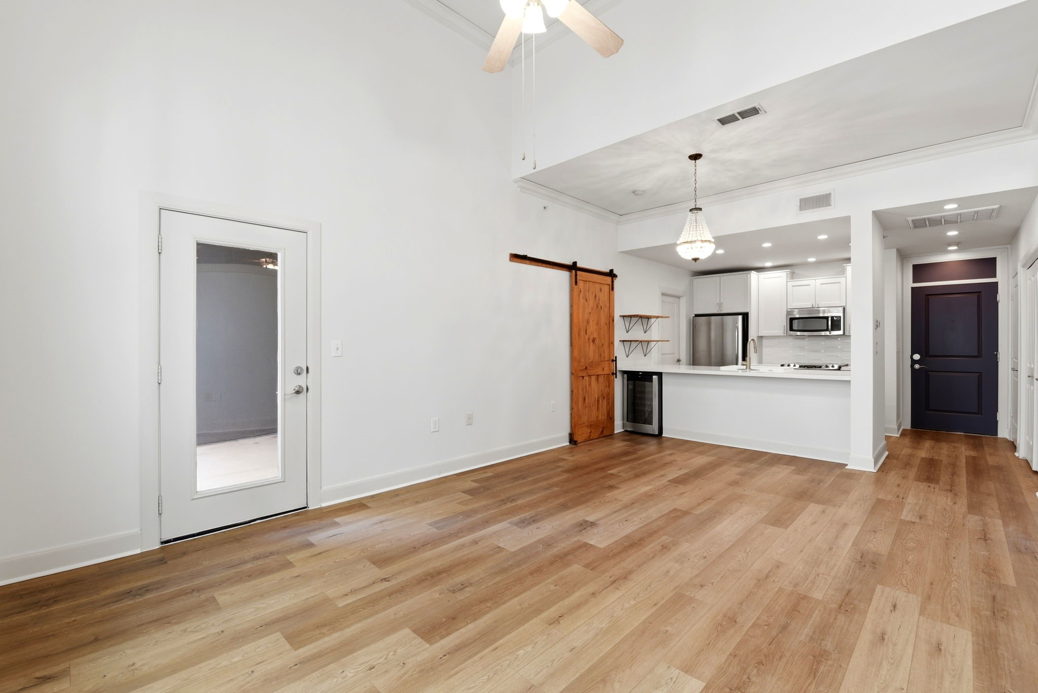 1010 Rosine Street, Unit 43 Houston, TX 77019 - Photo 26 of 48 a view of a kitchen with a sink a kitchen refrigerator and a chandelier fan