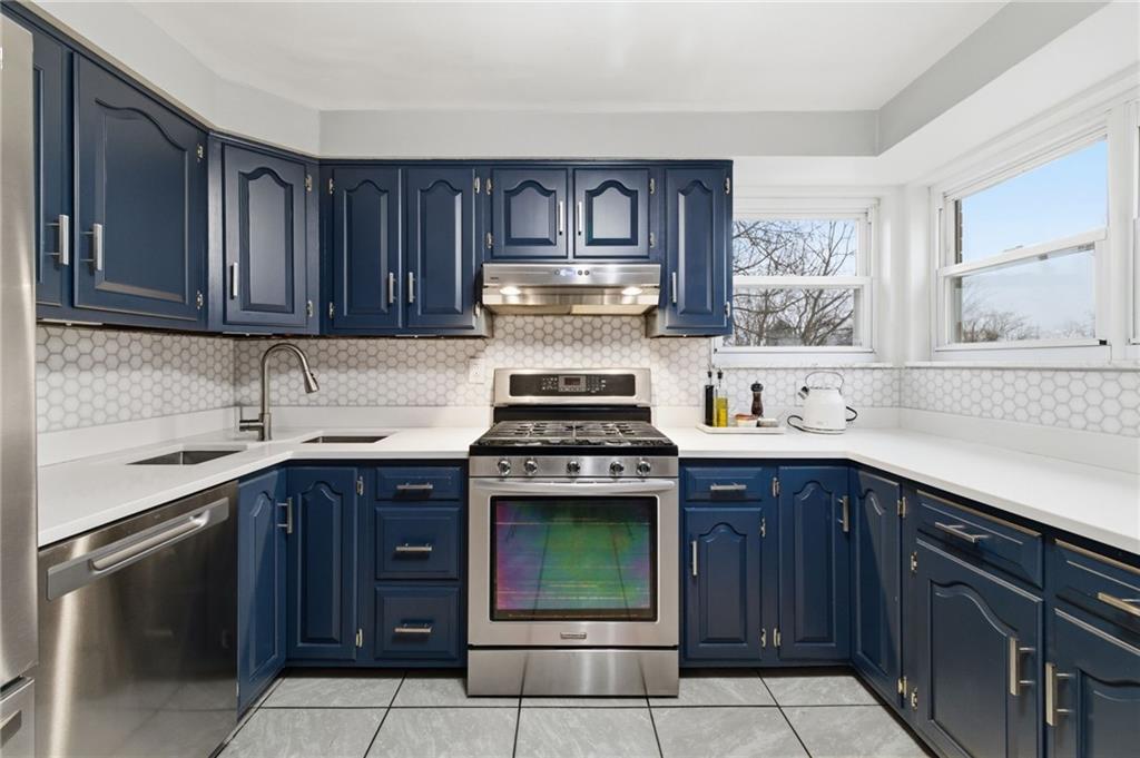 870 Middle Road Pittsburgh, PA 15234 - Photo 11 of 34 a kitchen with granite countertop stainless steel appliances a stove sink and cabinets