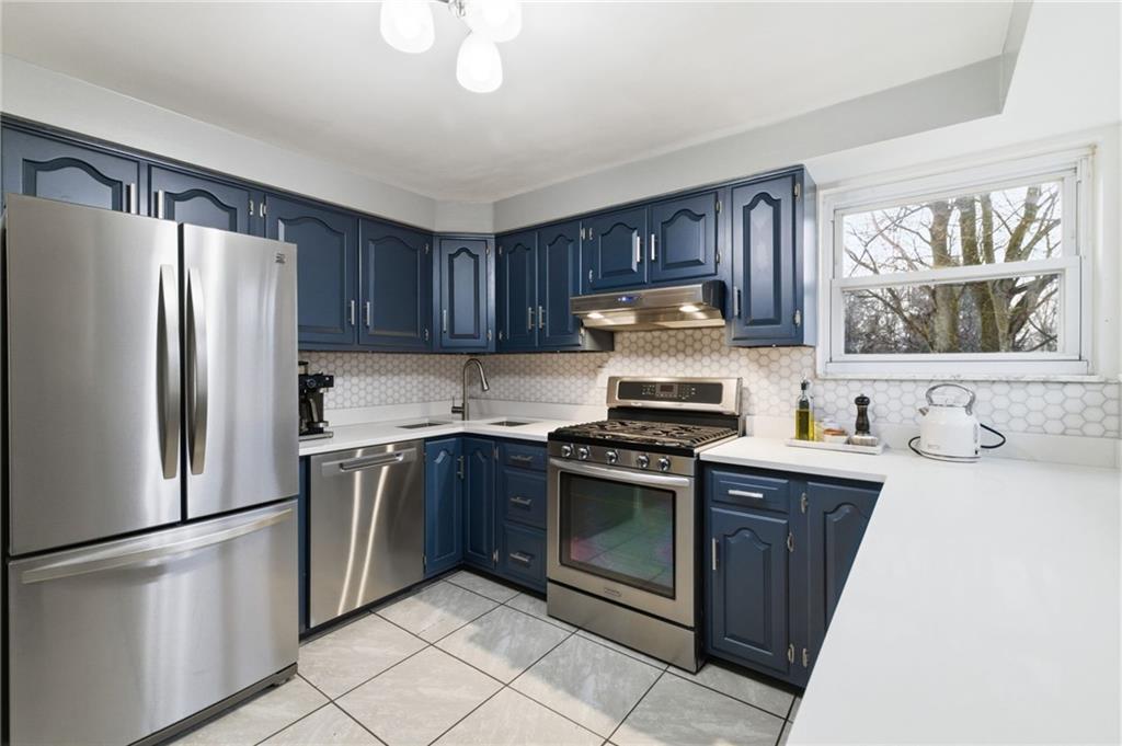 870 Middle Road Pittsburgh, PA 15234 - Photo 12 of 34 a kitchen with stainless steel appliances granite countertop a refrigerator sink and stove