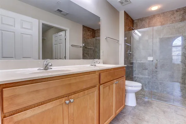 a bathroom with a double vanity sink and a mirror