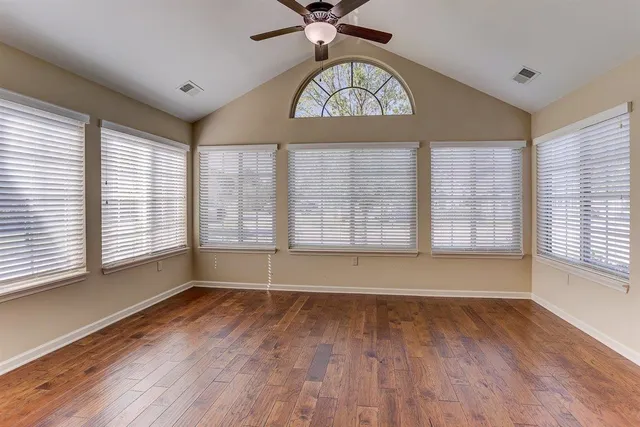 wooden floor in an empty room with a window