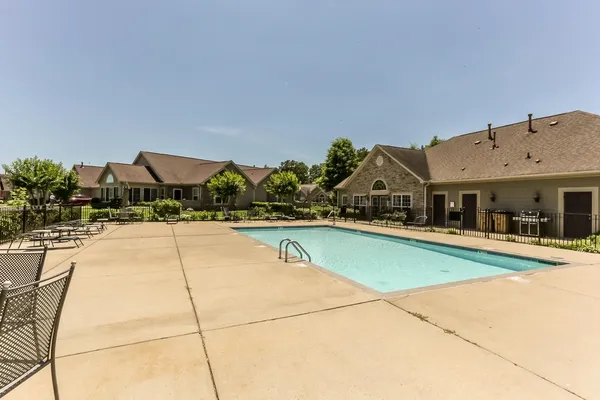a swimming pool with outdoor seating and yard