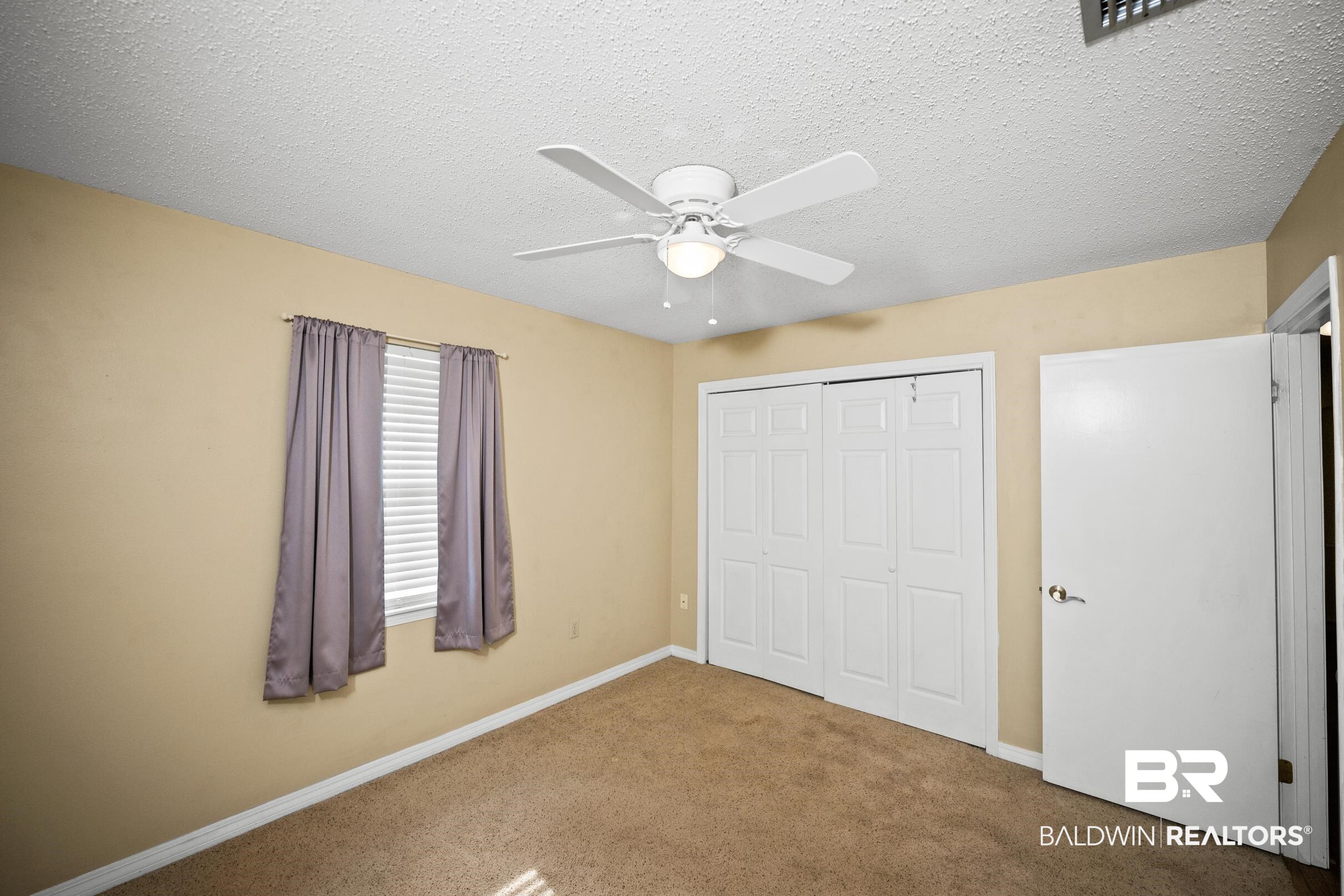 123 Dunbar Loop Daphne, AL 36526 - Photo 23 of 33 Unfurnished bedroom with a textured ceiling, a closet, carpet floors, and ceiling fan