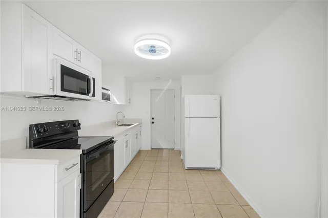 a kitchen with a refrigerator stove and microwave