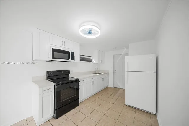 a view of a storage & utility room with a sink