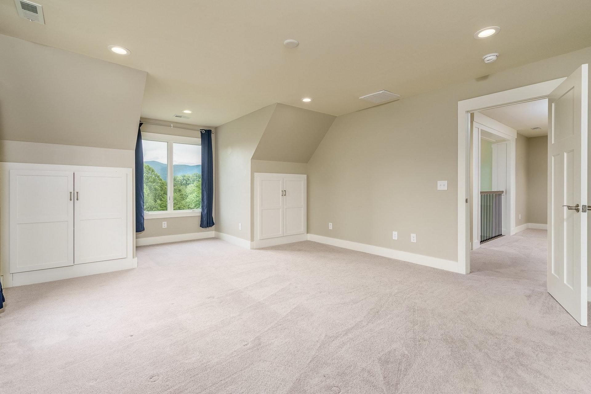 152 Cahas Summit Road Boones Mill, VA 24065 - Photo 14 of 63 an empty room with windows and pillars in it