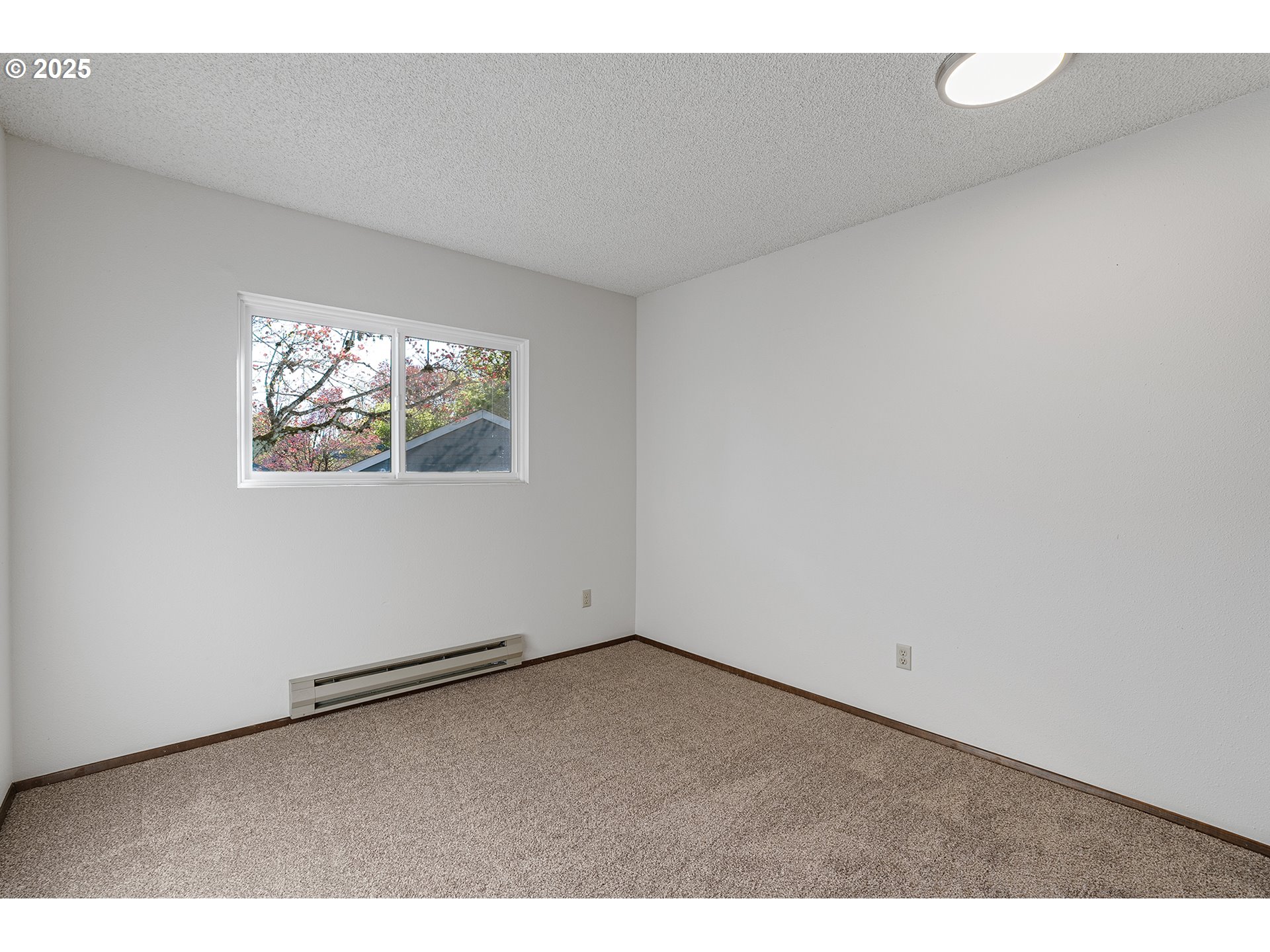 10915 Southwest Meadowbrook Drive, Unit 22 Portland, OR 97224 - Photo 12 of 23 an empty room with windows