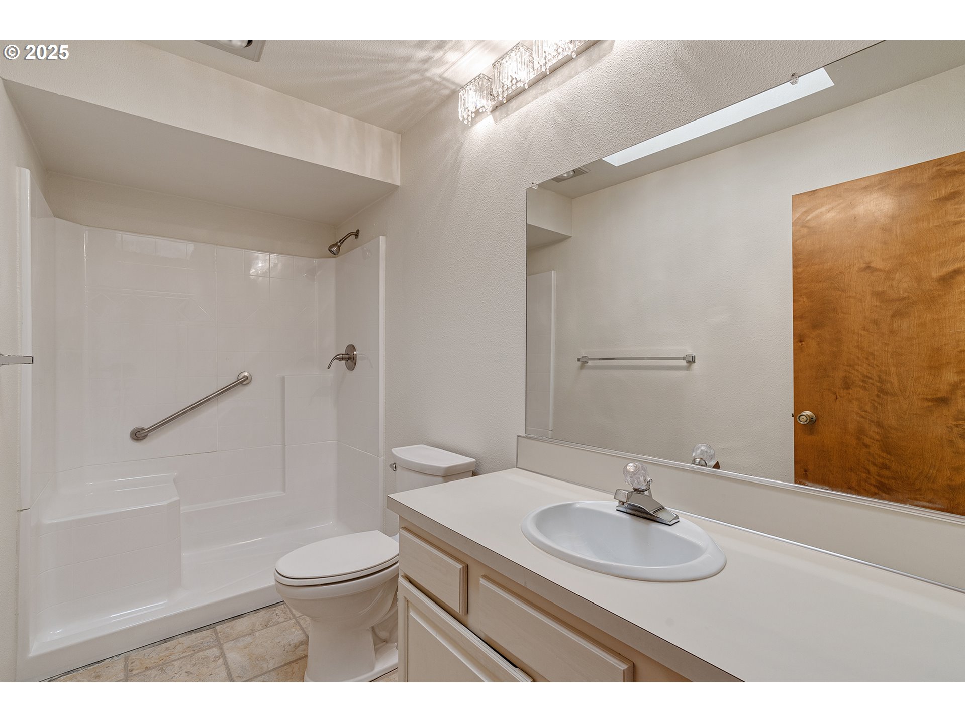 10915 Southwest Meadowbrook Drive, Unit 22 Portland, OR 97224 - Photo 18 of 23 a bathroom with a sink a toilet and shower