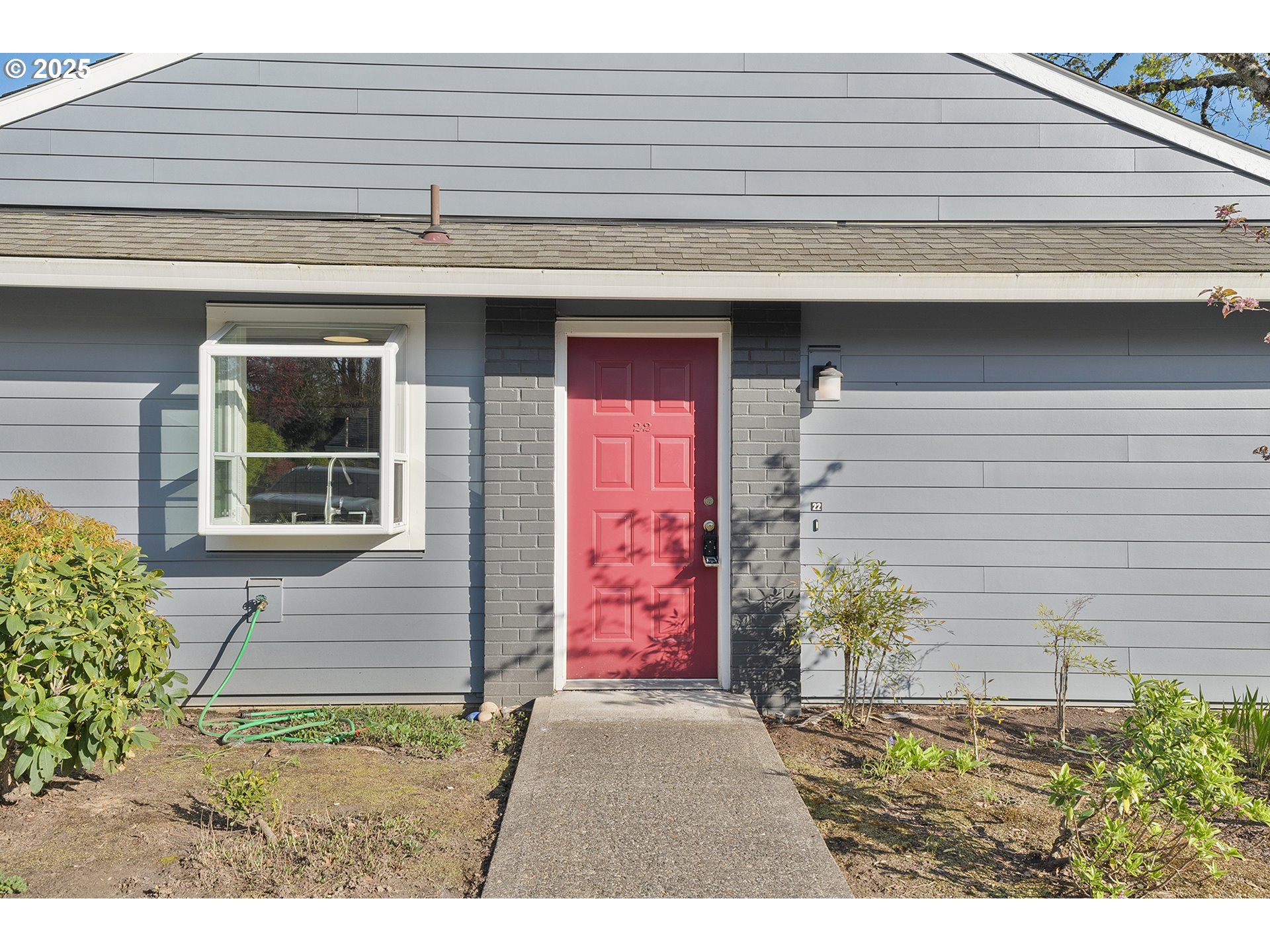 10915 Southwest Meadowbrook Drive, Unit 22 Portland, OR 97224 - Photo 2 of 23 a front view of a house with a yard