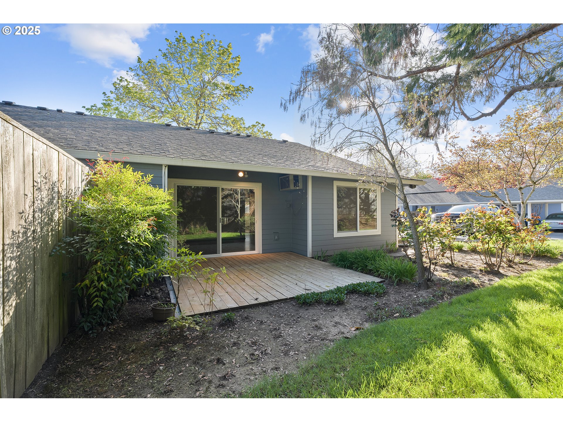 10915 Southwest Meadowbrook Drive, Unit 22 Portland, OR 97224 - Photo 23 of 23 a view of a house with a small yard and floor to ceiling window