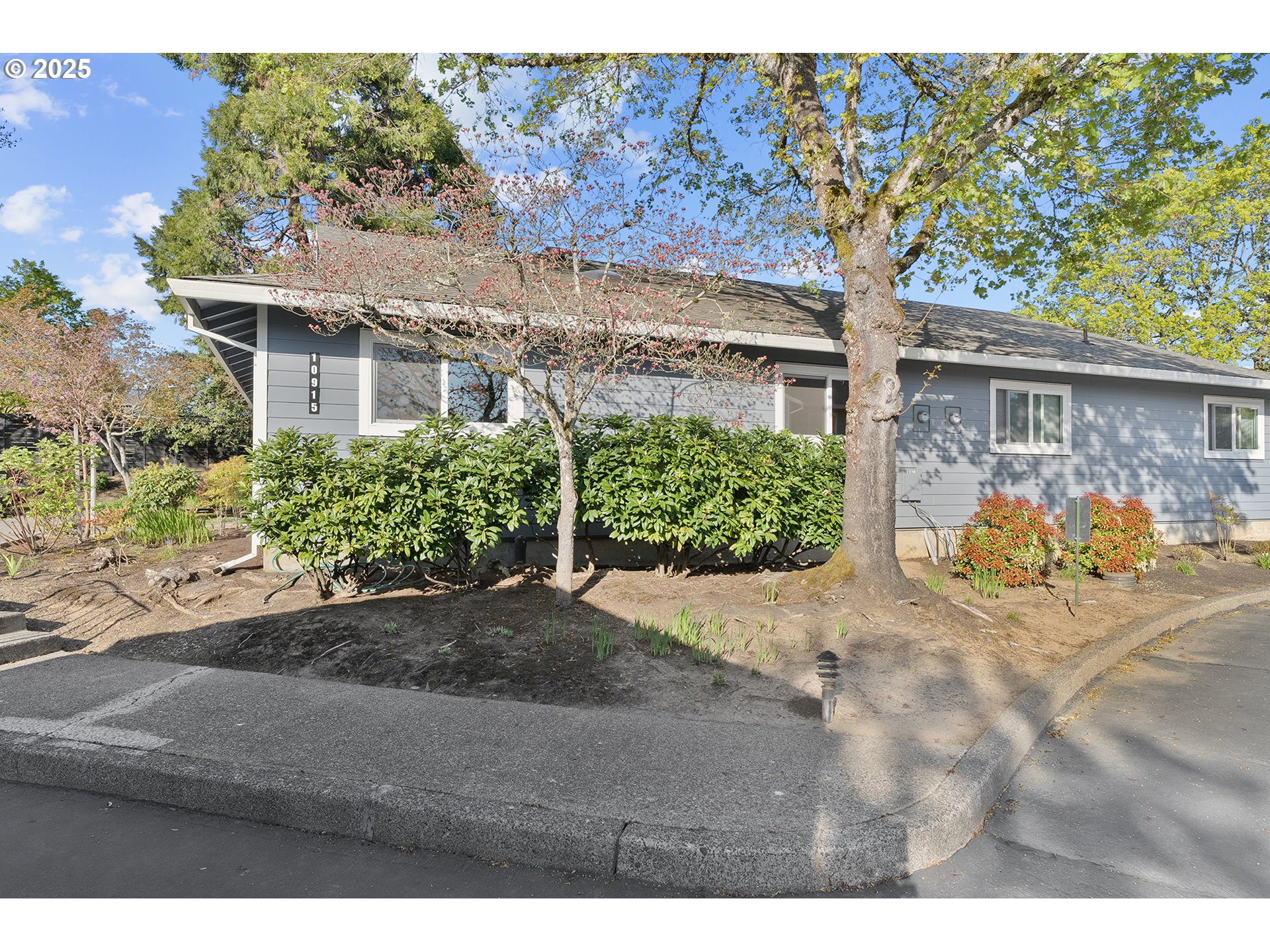 10915 Southwest Meadowbrook Drive, Unit 22 Portland, OR 97224 - Photo 3 of 23 a front view of a house with garden