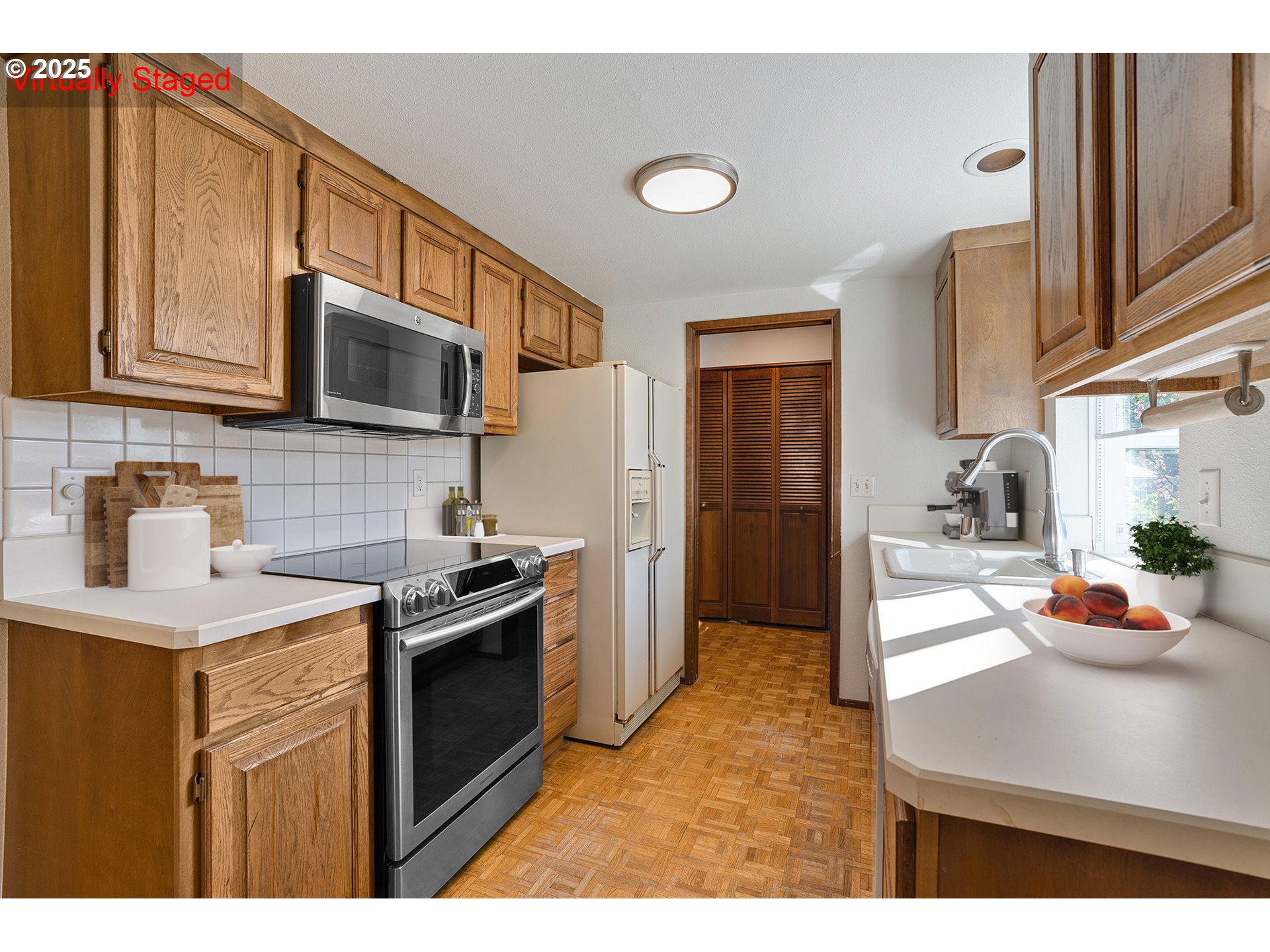 10915 Southwest Meadowbrook Drive, Unit 22 Portland, OR 97224 - Photo 7 of 23 a kitchen with stainless steel appliances granite countertop a sink stove and refrigerator