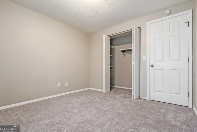 an empty room with closet area