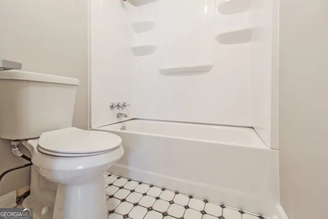 a bathroom with a toilet and a bathtub