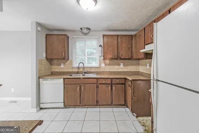 a kitchen with a sink cabinets and window
