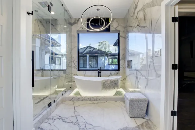 a spacious bathroom with a granite countertop sink a mirror and a shower