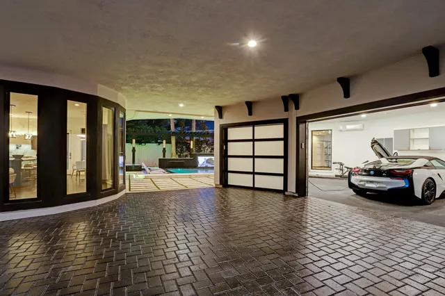 a view of a livingroom with furniture and floor to ceiling window