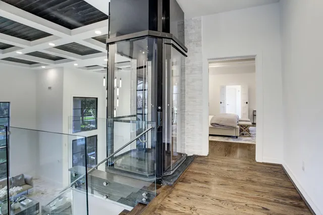 a view of a hallway view with living room and wooden floor