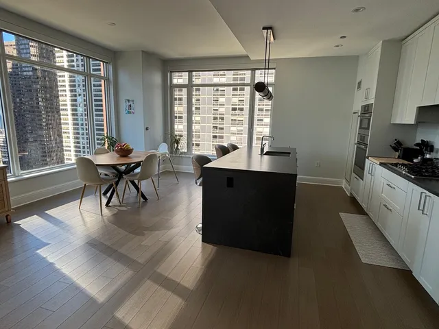 a living room with furniture and large windows