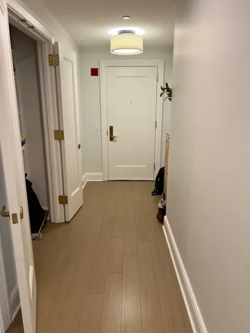 a view of a room with wooden floor