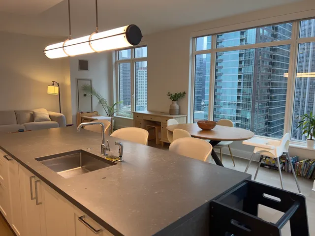 a kitchen with a table chairs sink and cabinets